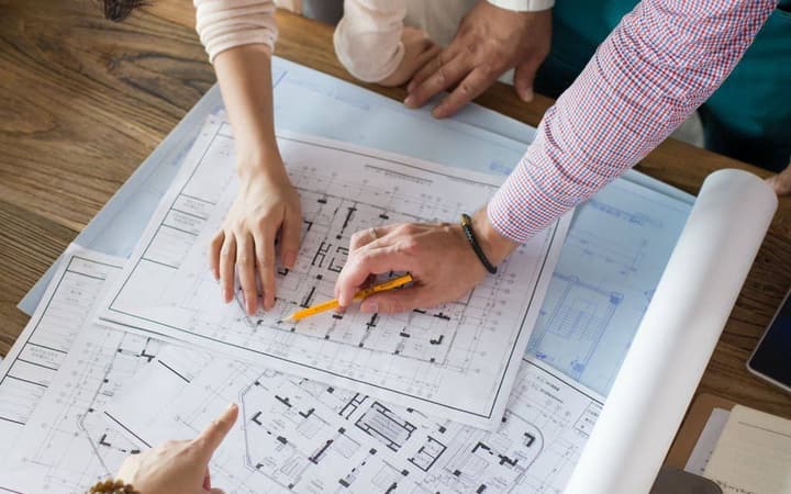 Investor and engineer reviewing building plans for a cost segregation study