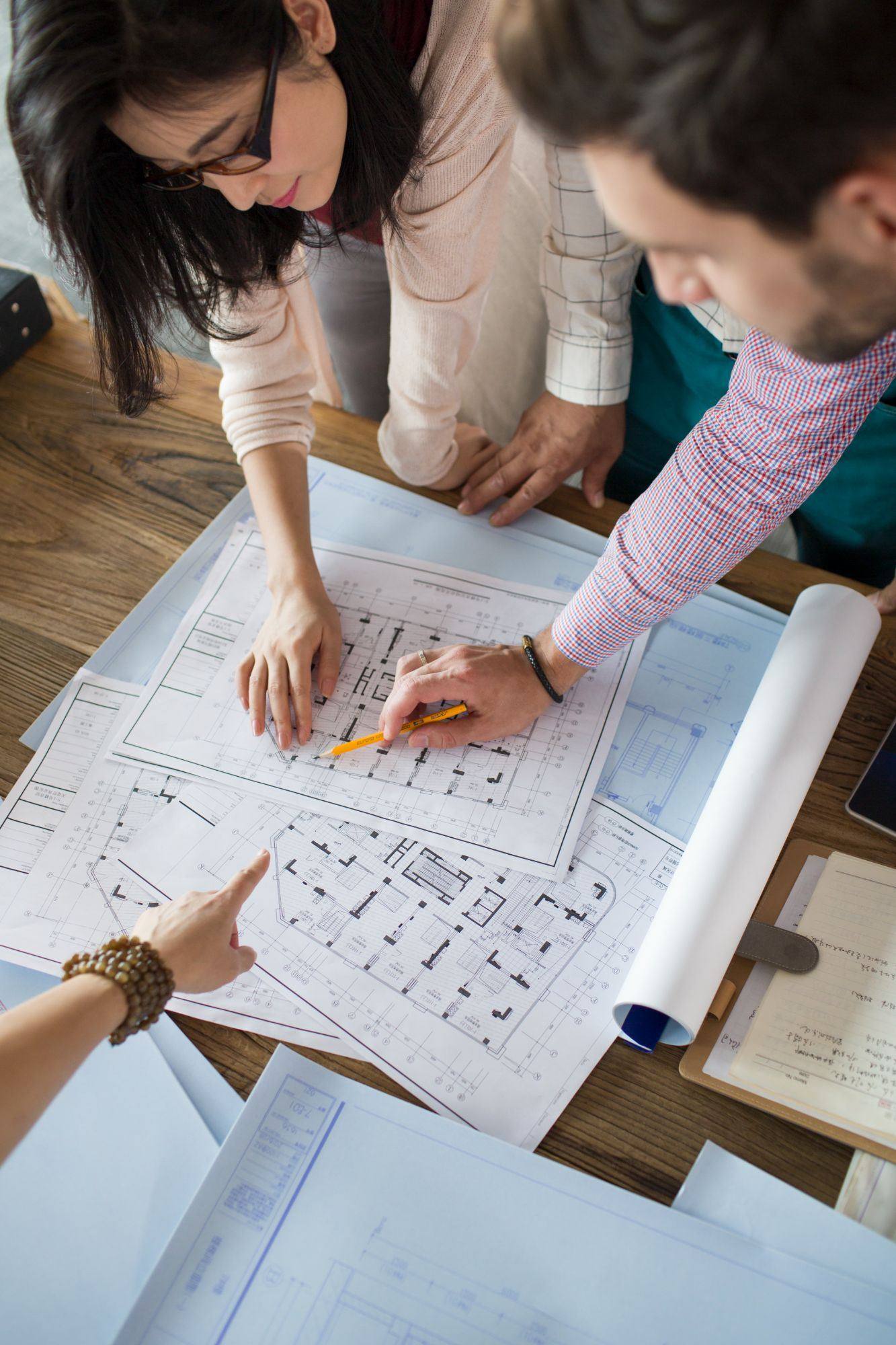 Investor and engineer reviewing building plans for a cost segregation study