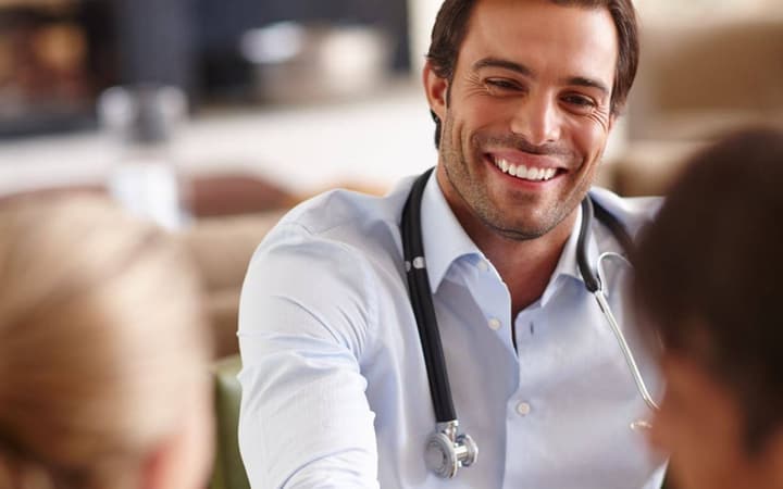 Concierge physician greeting patients warmly