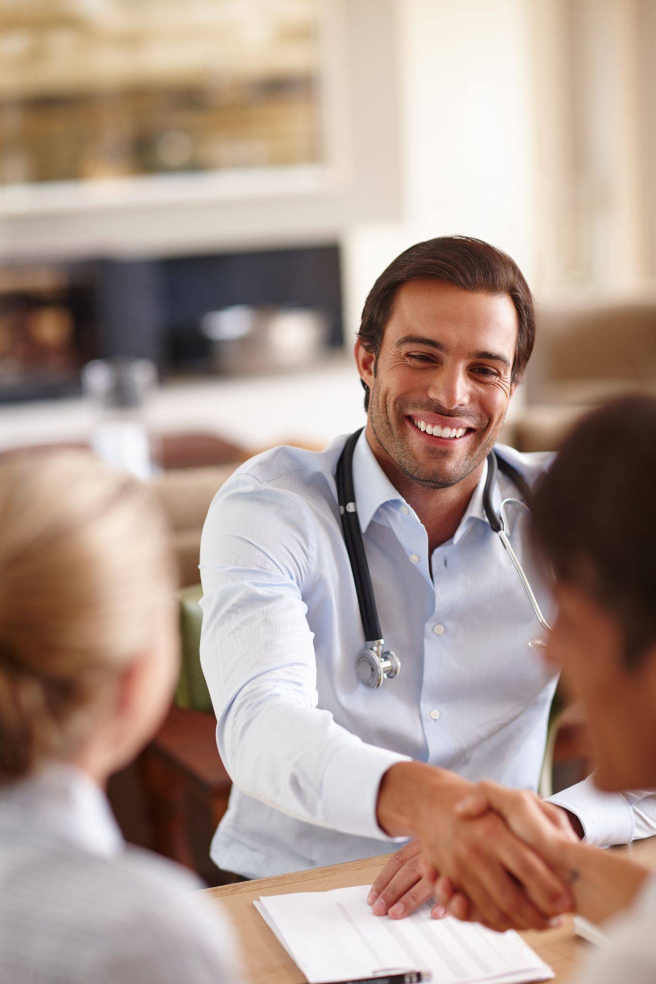 Concierge physician greeting patients warmly