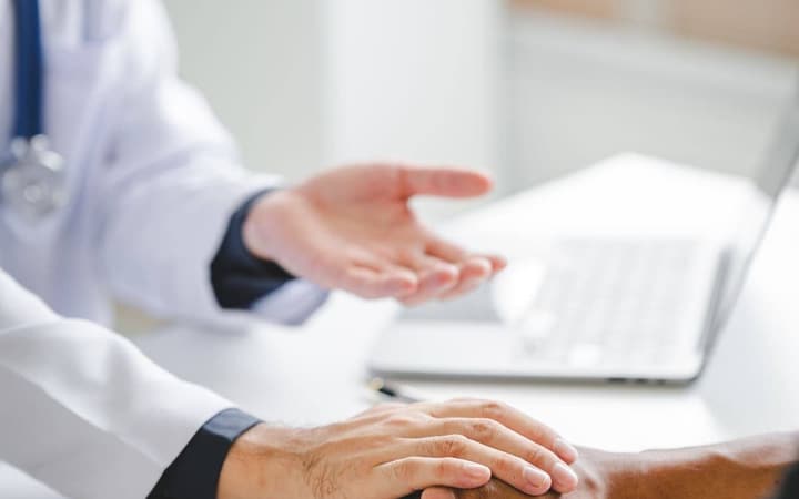 Direct primary care physician greeting a patient at check-in
