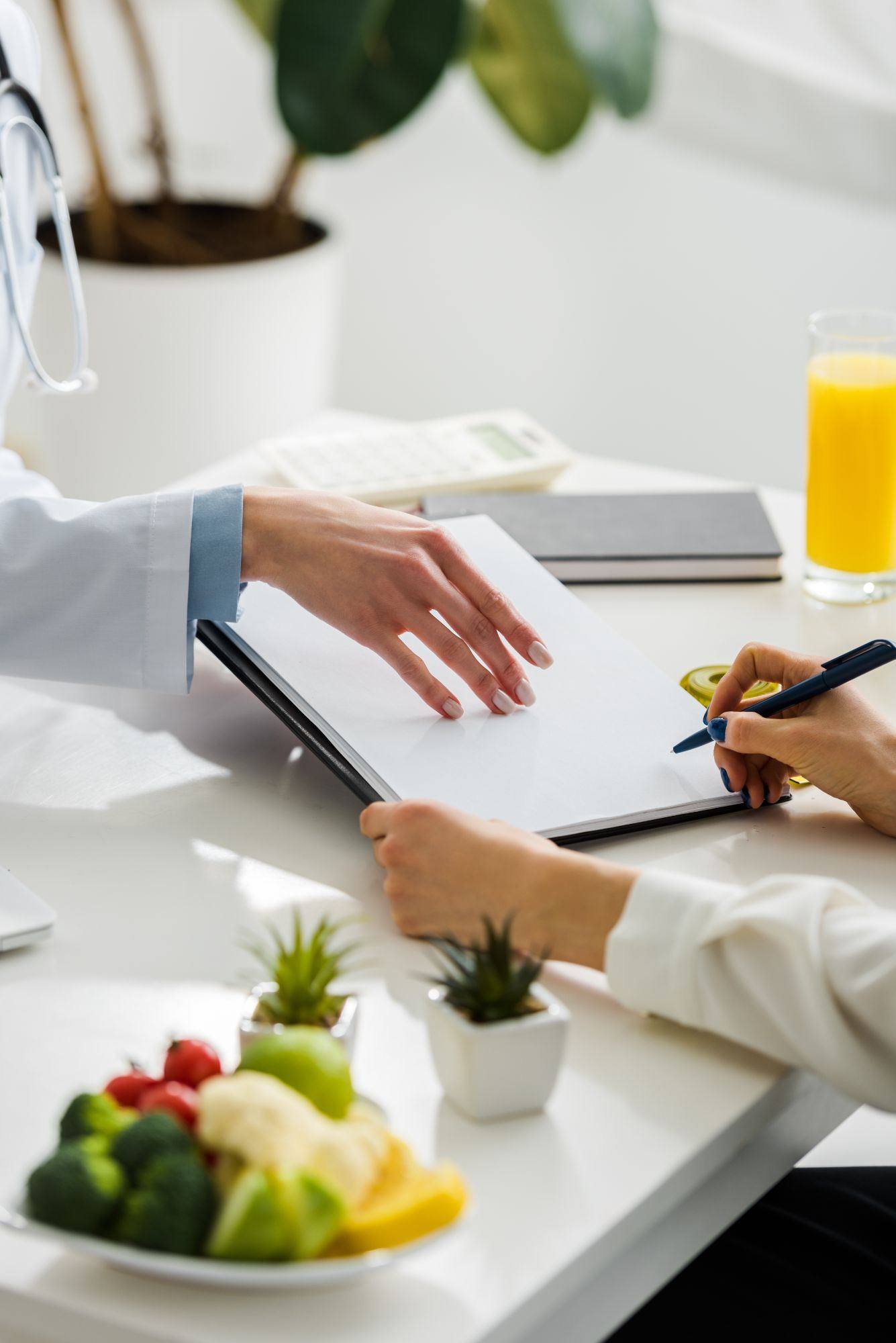 Functional medicine consultation with nutrition notes and fresh produce