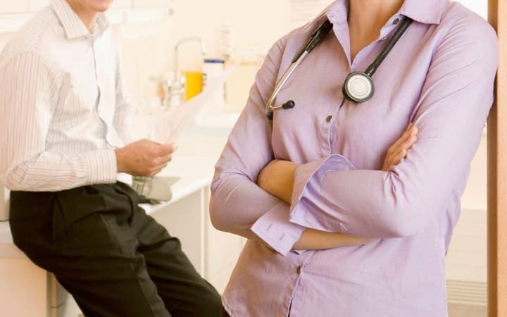 Longevity clinic providers consulting in an exam room