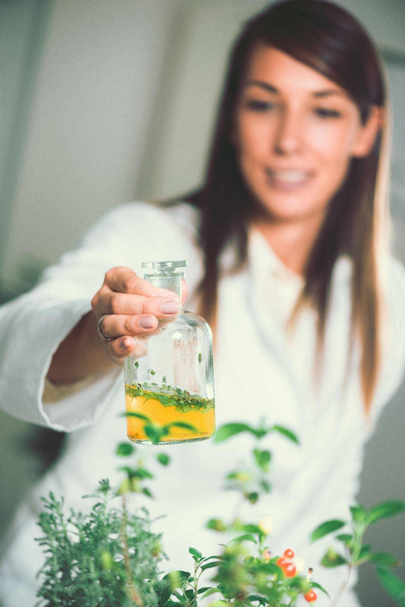 Naturopathic practitioner preparing an herbal tincture