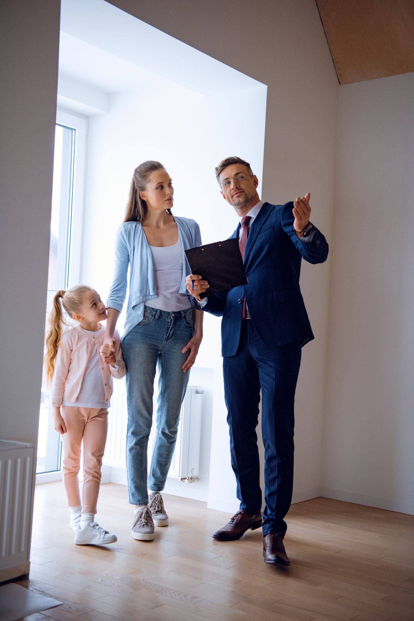 Real estate agent showing a property to a family